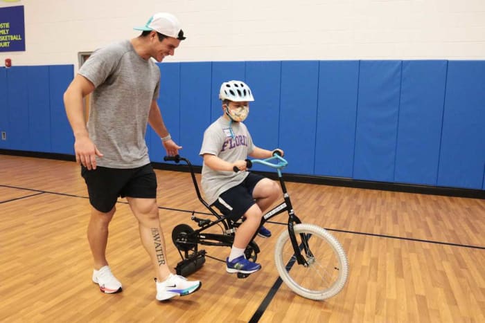 Jacksonville Jaguars kicker Josh Lambo(left) guides 10-year-old Drew Crass, during Tuesday's IBike Camp at the North Florida School of Special Education. Lambo sponsors the camp's first appearance in Jacksonville, and helped in sessions. © Lawren Simmons/Florida Times-Union